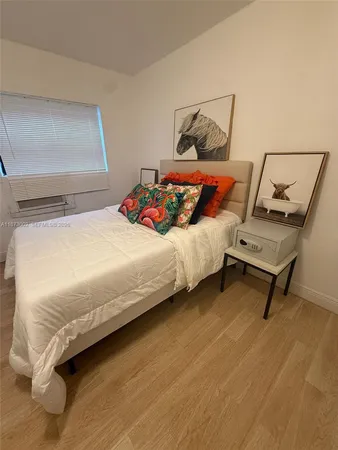 a bedroom with a bed and painting on the wall