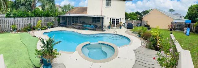 an aerial view of a house with swimming pool garden and patio