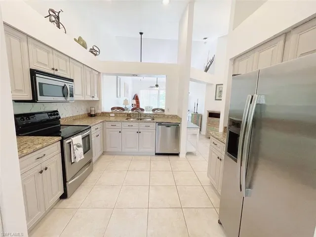 a kitchen with stainless steel appliances and white cabinets