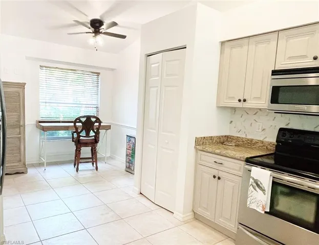 a kitchen with cabinets and appliances
