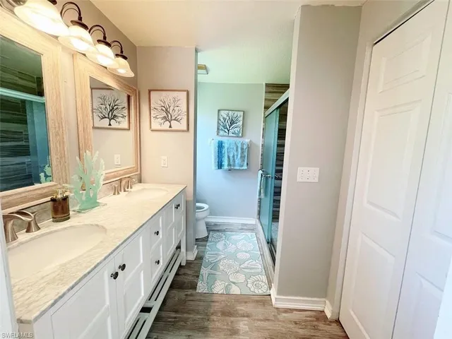 a bathroom with a double vanity sink and a mirror