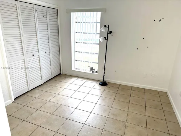 an empty room with white walls and tiles