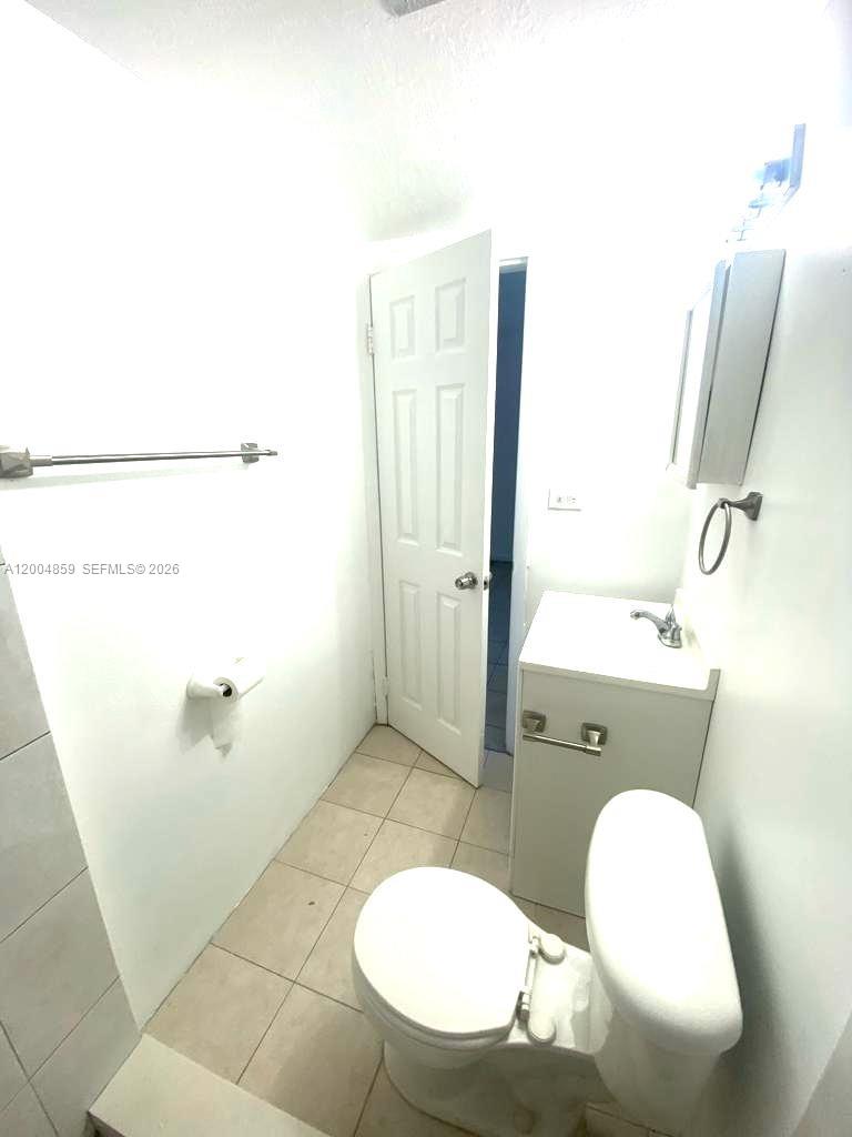 7256 Southwest 94th Place, Unit A4 Miami, FL 33173 - Photo 15 of 18 a bathroom with a sink mirror vanity and toilet