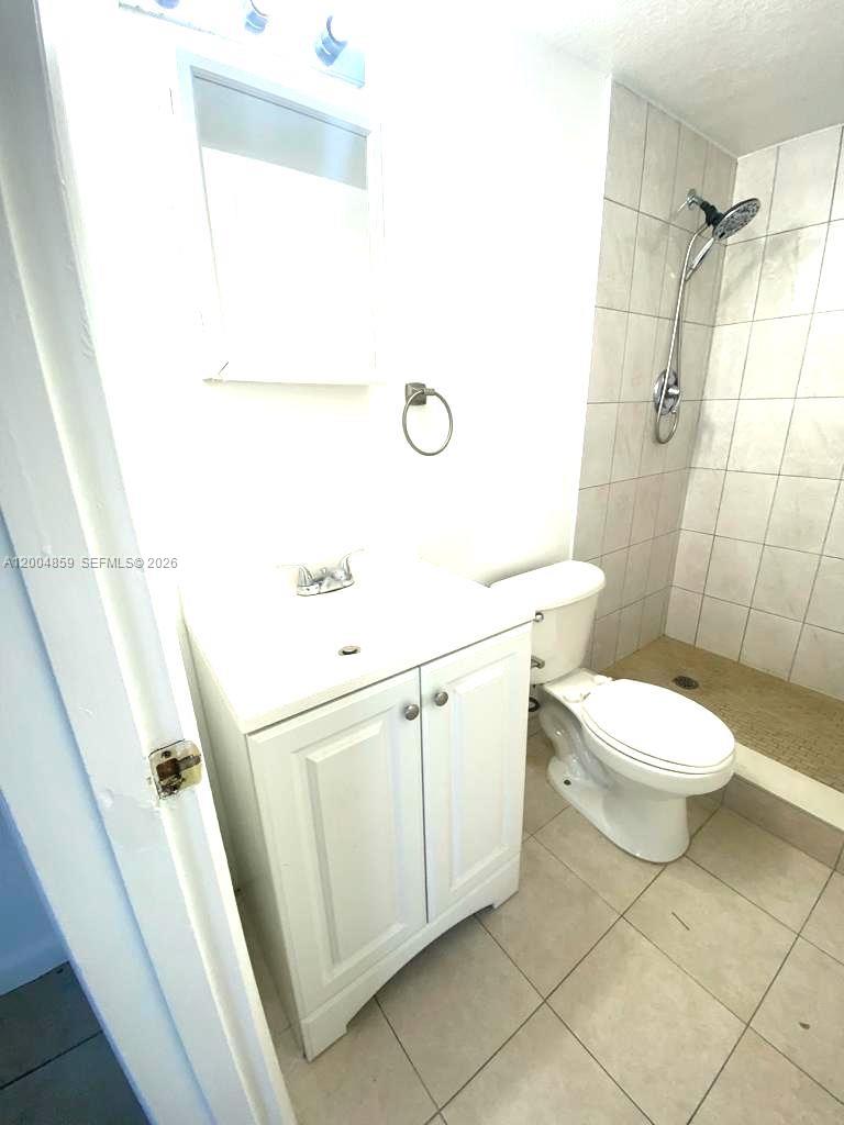 7256 Southwest 94th Place, Unit A4 Miami, FL 33173 - Photo 16 of 18 a bathroom with a sink a toilet and shower
