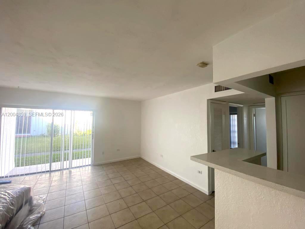7256 Southwest 94th Place, Unit A4 Miami, FL 33173 - Photo 5 of 18 a view of a kitchen with a sink and a window