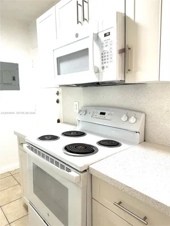a kitchen with a stove and a microwave