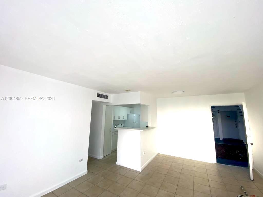 7256 Southwest 94th Place, Unit A4 Miami, FL 33173 - Photo 8 of 18 a view of a kitchen with refrigerator and a sink