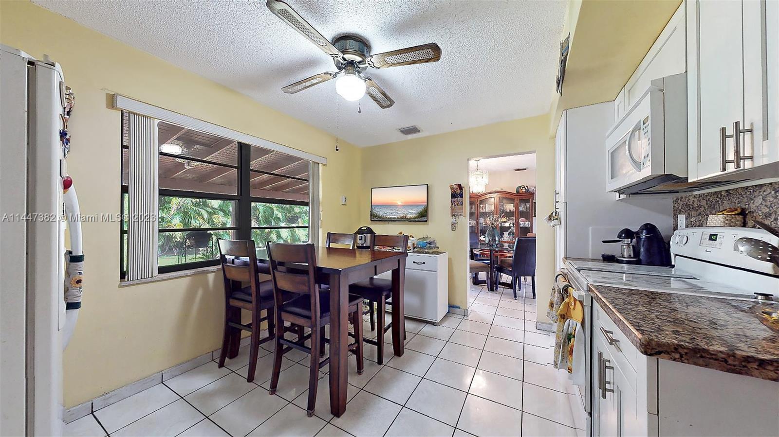 9815 Southwest 77th Street Miami, FL 33173 - Photo 11 of 30 a view of a dining room with furniture window and outside view