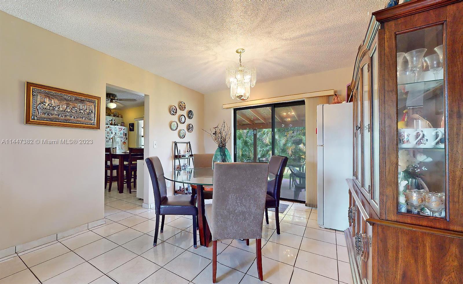 9815 Southwest 77th Street Miami, FL 33173 - Photo 14 of 30 a view of a dining room with furniture window and outside view