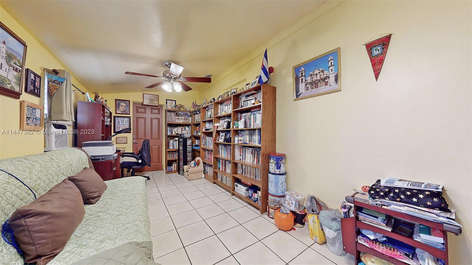 9815 Southwest 77th Street Miami, FL 33173 - Photo 15 of 30 a living room with lots of furniture and a bookshelf