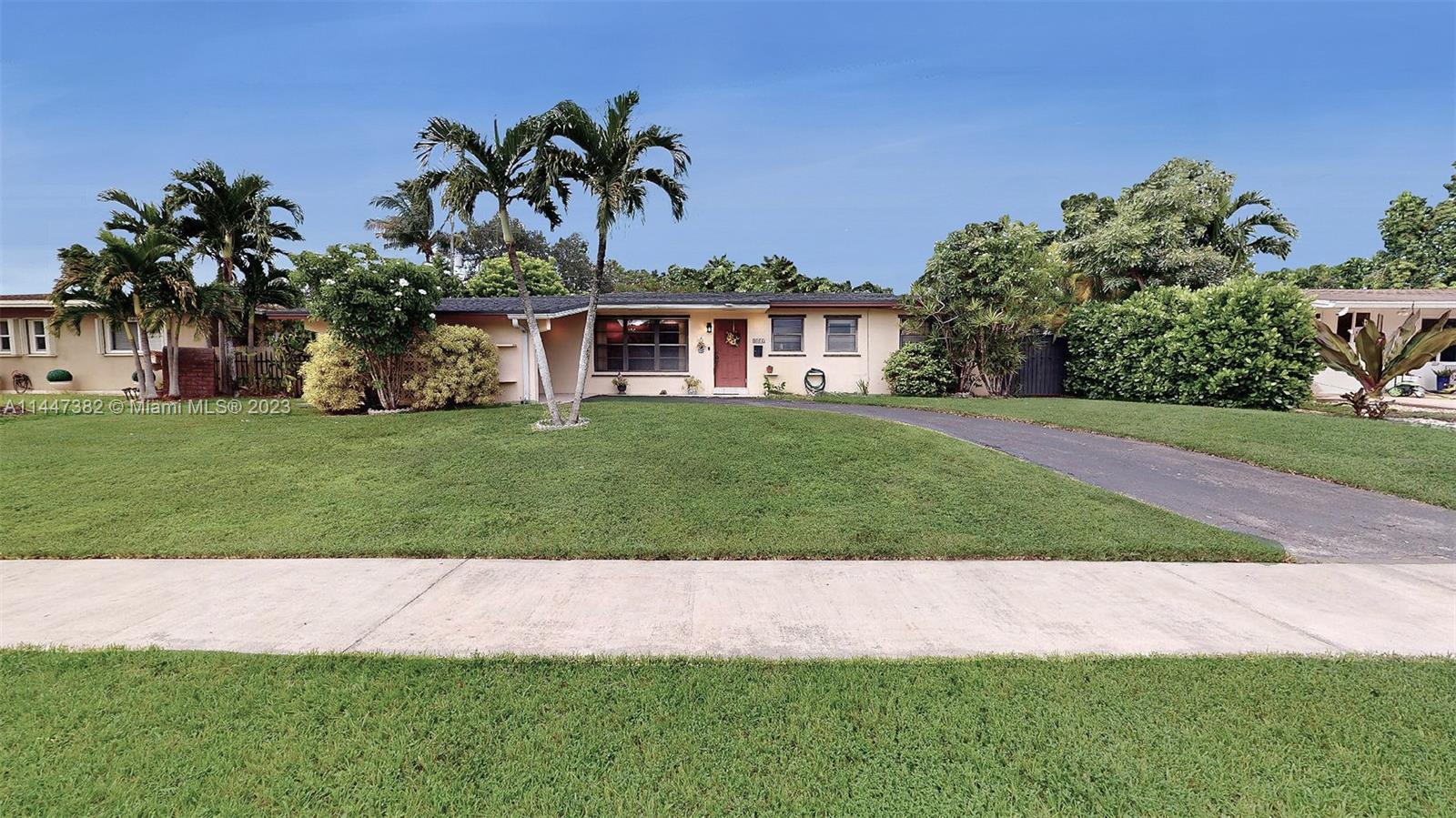 9815 Southwest 77th Street Miami, FL 33173 - Photo 2 of 30 a front view of a house with a garden