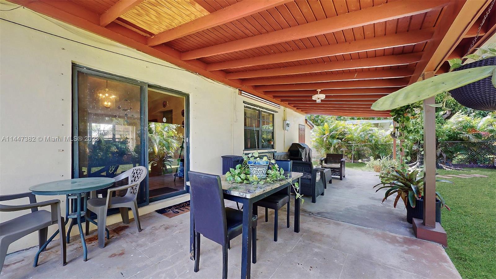 9815 Southwest 77th Street Miami, FL 33173 - Photo 23 of 30 a view of a patio with table and chairs and potted plants