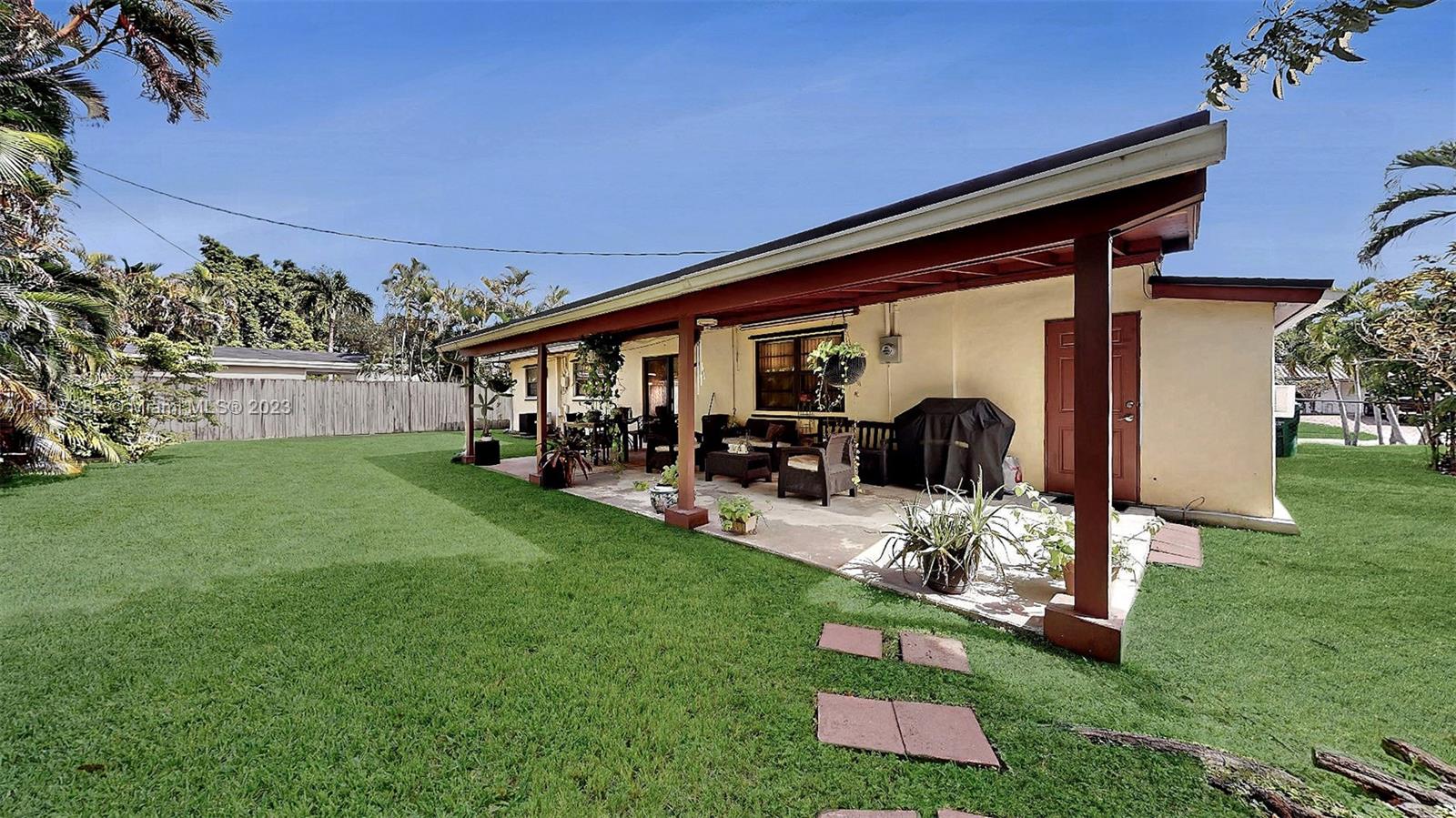 9815 Southwest 77th Street Miami, FL 33173 - Photo 27 of 30 a front view of a house with garden and sitting area