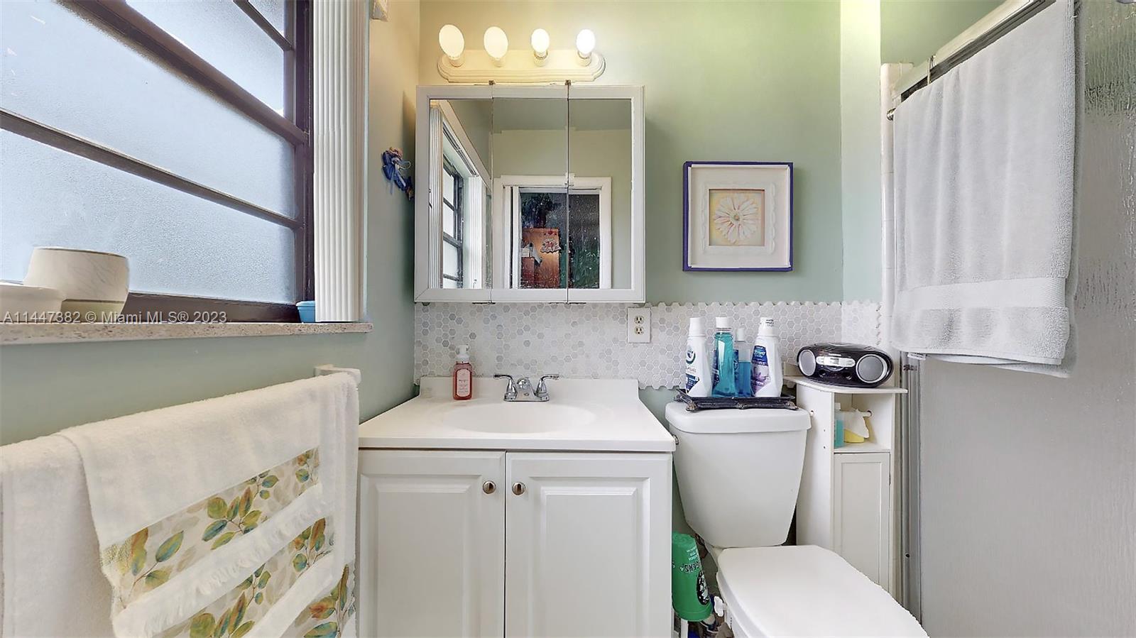 9815 Southwest 77th Street Miami, FL 33173 - Photo 5 of 30 a bathroom with a sink toilet and mirror