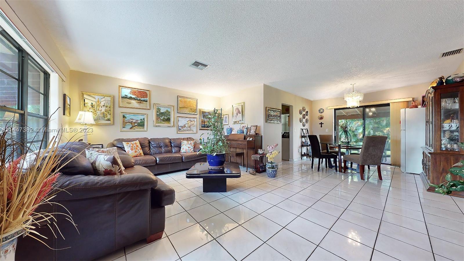 9815 Southwest 77th Street Miami, FL 33173 - Photo 6 of 30 a living room with furniture and a large window