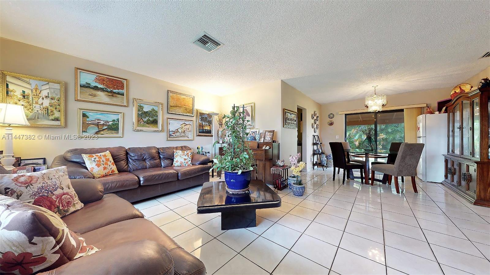 9815 Southwest 77th Street Miami, FL 33173 - Photo 7 of 30 a living room with furniture and a large window