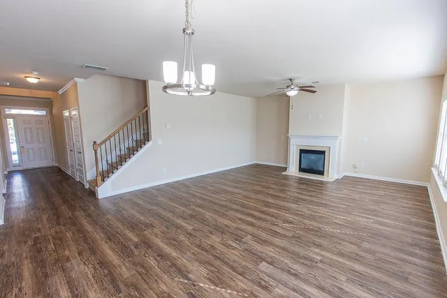 a view of a kitchen with wooden floor and a window