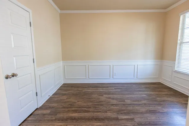 a view of wooden floor and windows in a room