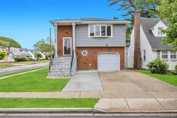 a front view of a house with a yard and garage