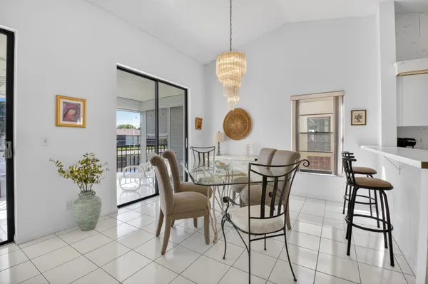 a view of a dining room with furniture and chandelier