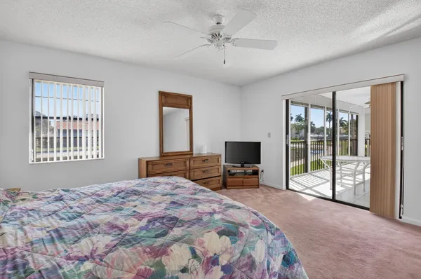 a bedroom with a bed and a large mirror on dresser