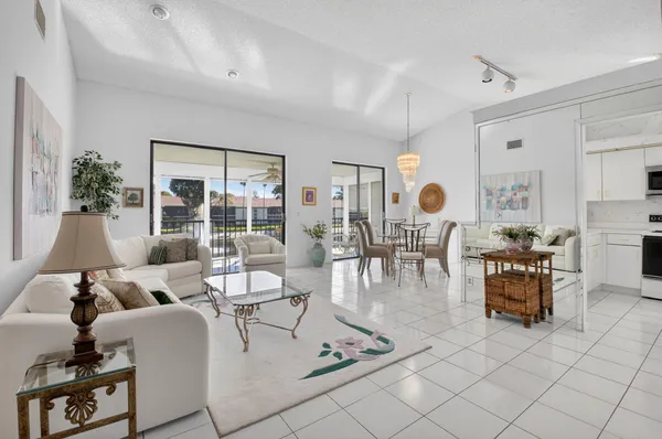 a living room with fireplace furniture and a large window