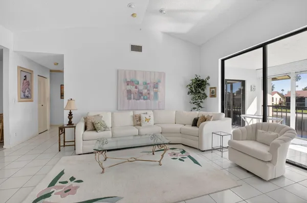 a living room with furniture and a large window