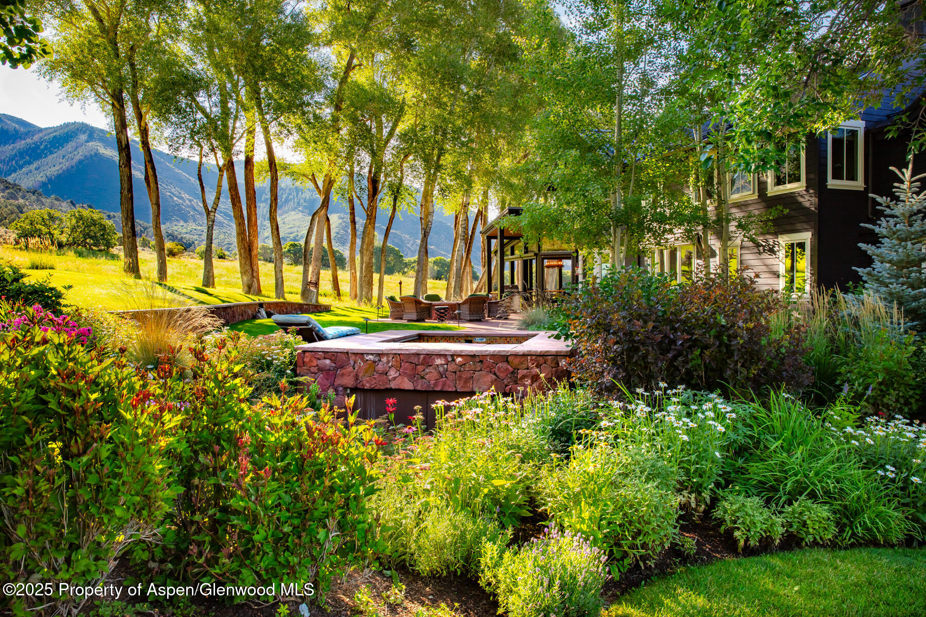 2147 Lower River Road Snowmass, CO 81654 - Photo 46 of 61 a view of a house with a yard