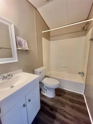 a bathroom with a toilet sink and shower