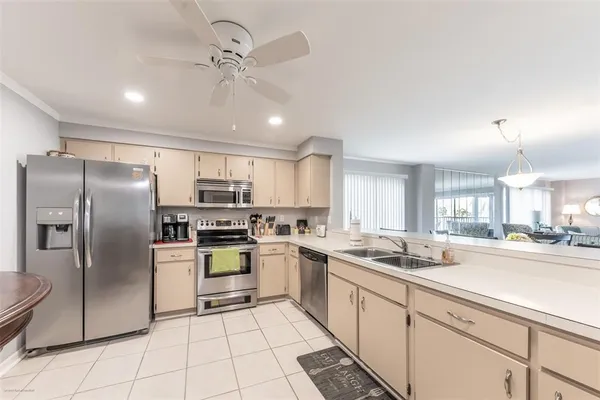 a kitchen with a refrigerator a sink and cabinets