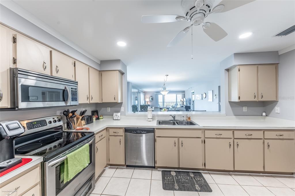 1477 Park Beach Circle, Unit 11 Punta Gorda, FL 33950 - Photo 16 of 49 a kitchen with a sink stove and cabinets