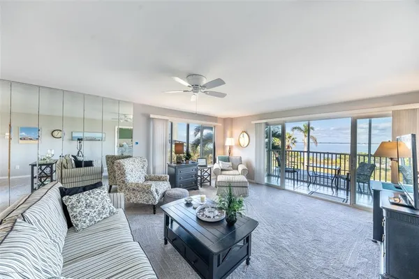 a living room with furniture and a floor to ceiling window