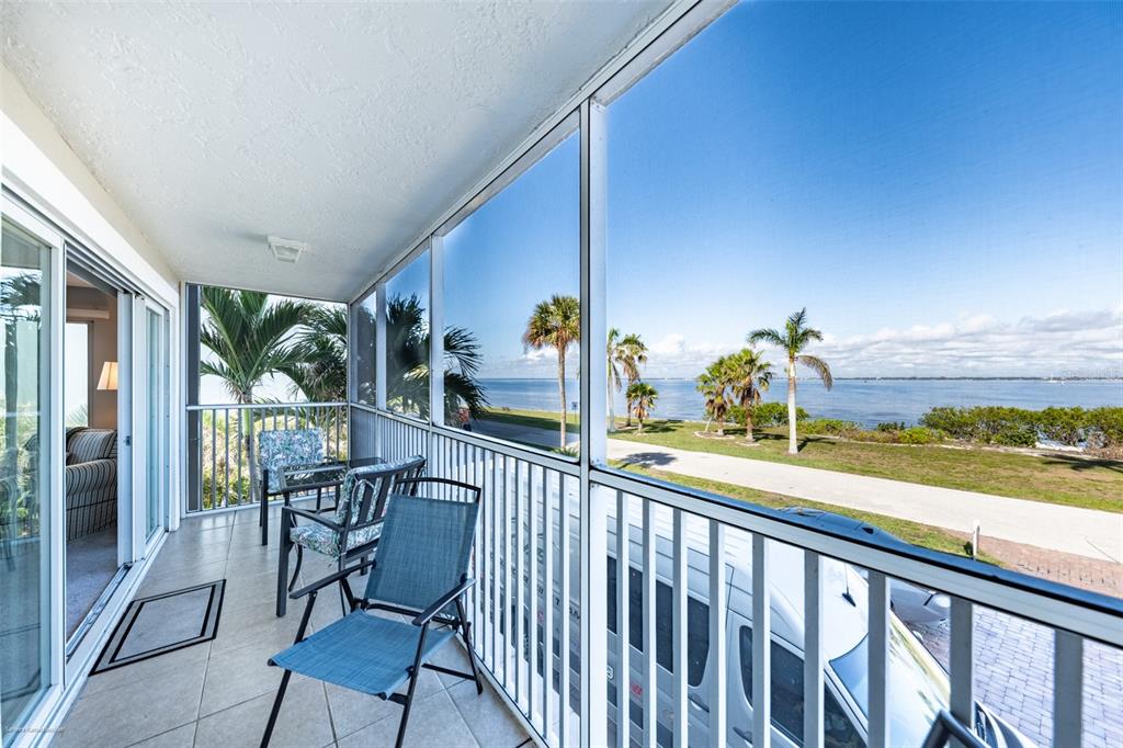 1477 Park Beach Circle, Unit 11 Punta Gorda, FL 33950 - Photo 27 of 49 a view of a chairs and table in patio with wooden floor