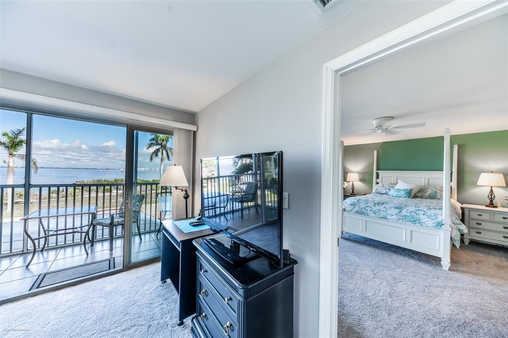 1477 Park Beach Circle, Unit 11 Punta Gorda, FL 33950 - Photo 29 of 49 a bedroom with furniture and large windows