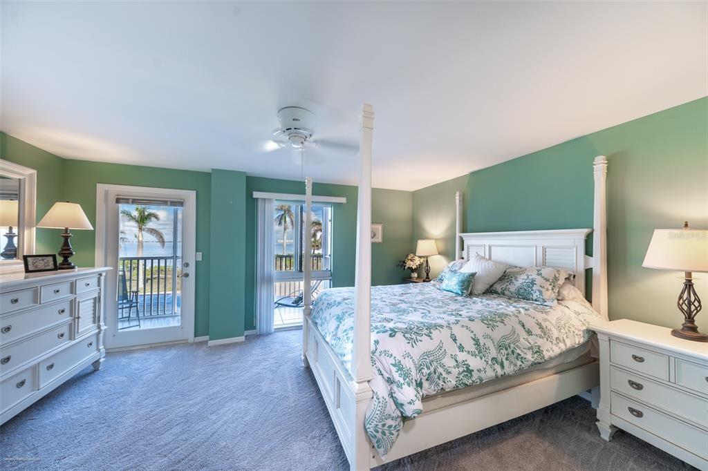 1477 Park Beach Circle, Unit 11 Punta Gorda, FL 33950 - Photo 31 of 49 a bedroom with a large bed and a chandelier