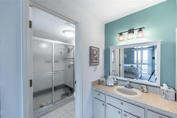 a bathroom with a shower sink and mirror