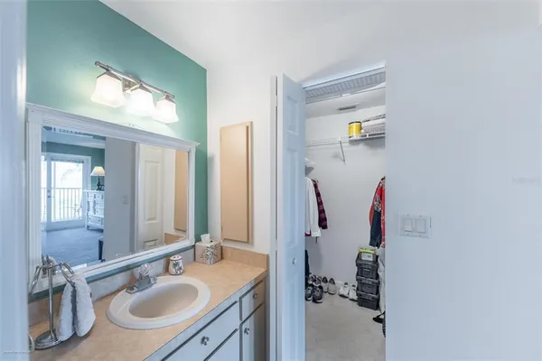 a bathroom with a sink vanity and mirror