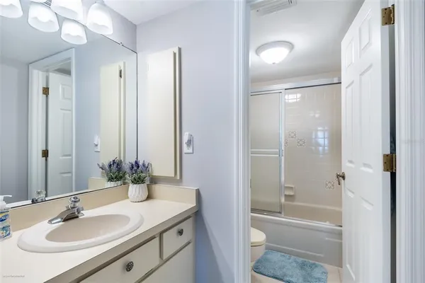 a bathroom with a sink toilet tub and shower