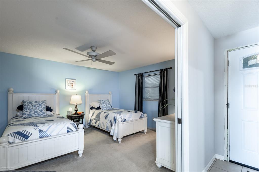1477 Park Beach Circle, Unit 11 Punta Gorda, FL 33950 - Photo 8 of 49 a bedroom with a bed and a chandelier