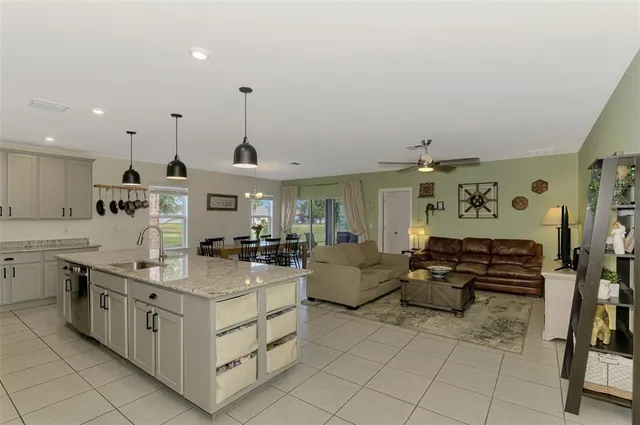a kitchen with stainless steel appliances kitchen island granite countertop a sink and cabinets