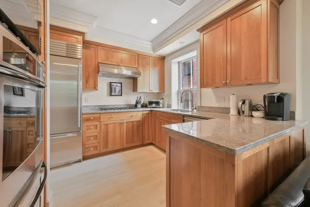 a kitchen with stainless steel appliances granite countertop a sink stove and refrigerator