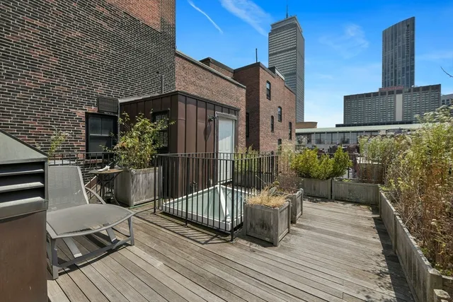 a view of a deck with furniture and wooden floor