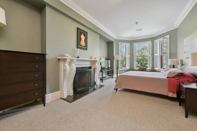 a spacious bedroom with a bed and a fireplace