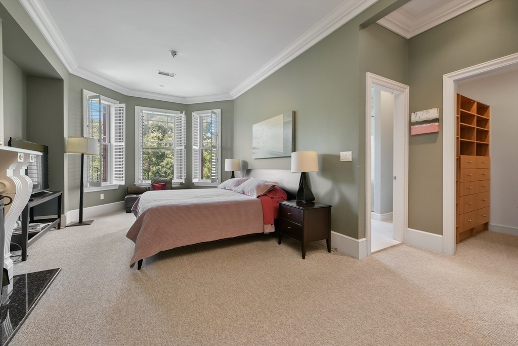 294 Commonwealth Avenue, Unit 2 Boston, MA 02115 - Photo 17 of 26 a spacious bedroom with a bed couch and a large window