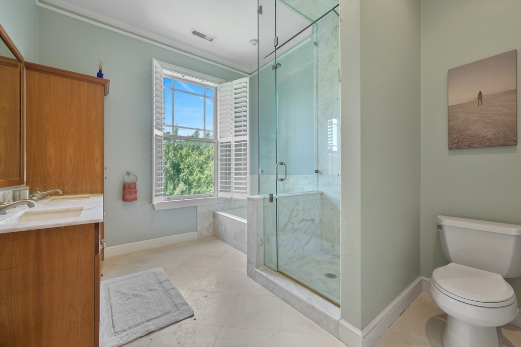 294 Commonwealth Avenue, Unit 2 Boston, MA 02115 - Photo 18 of 26 a bathroom with a granite countertop sink a toilet and shower