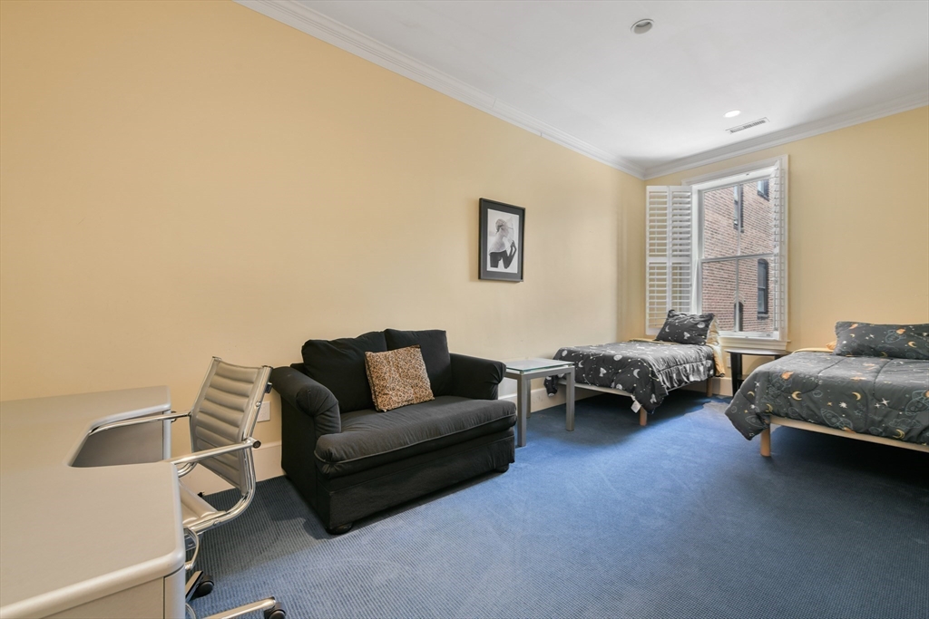 294 Commonwealth Avenue, Unit 2 Boston, MA 02115 - Photo 20 of 26 a living room with furniture and a window