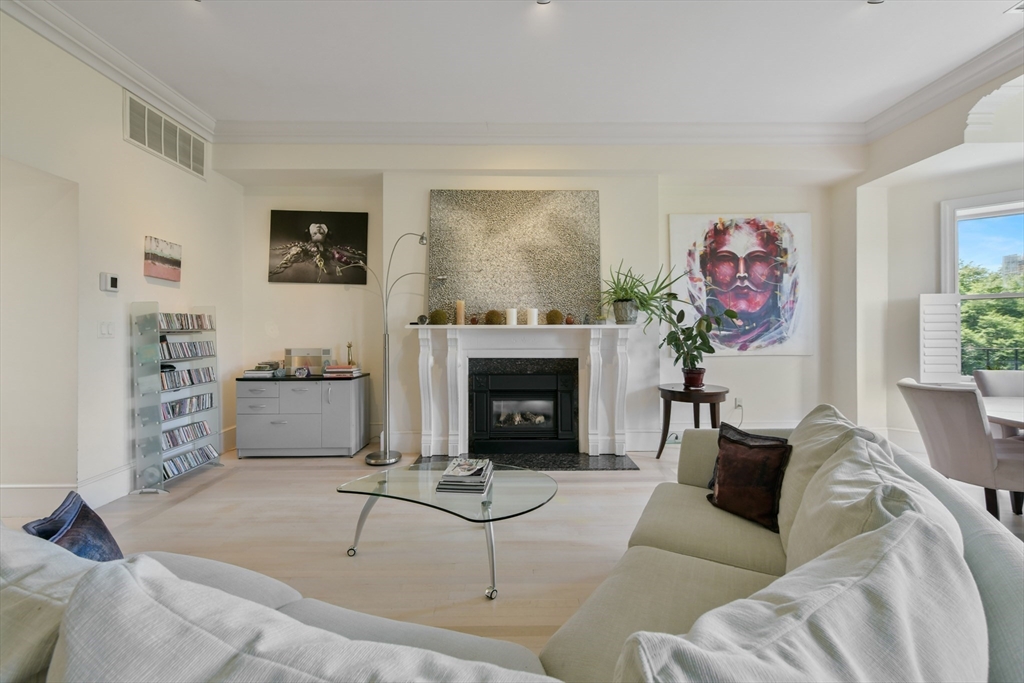 294 Commonwealth Avenue, Unit 2 Boston, MA 02115 - Photo 6 of 26 a living room with furniture a fireplace and wall paintings