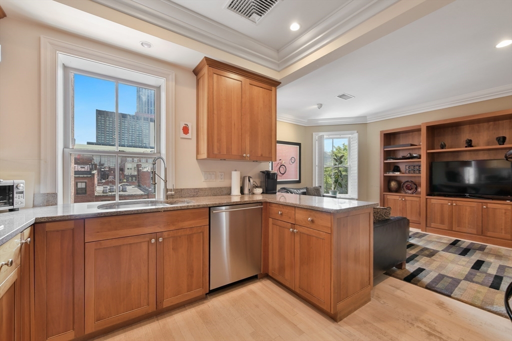 294 Commonwealth Avenue, Unit 2 Boston, MA 02115 - Photo 10 of 26 a kitchen with stainless steel appliances a stove sink and microwave