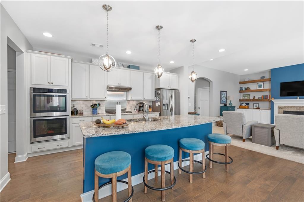 39 Floating Leaf Way Dallas, GA 30132 - Photo 12 of 40 a kitchen with kitchen island granite countertop a table and chairs in it