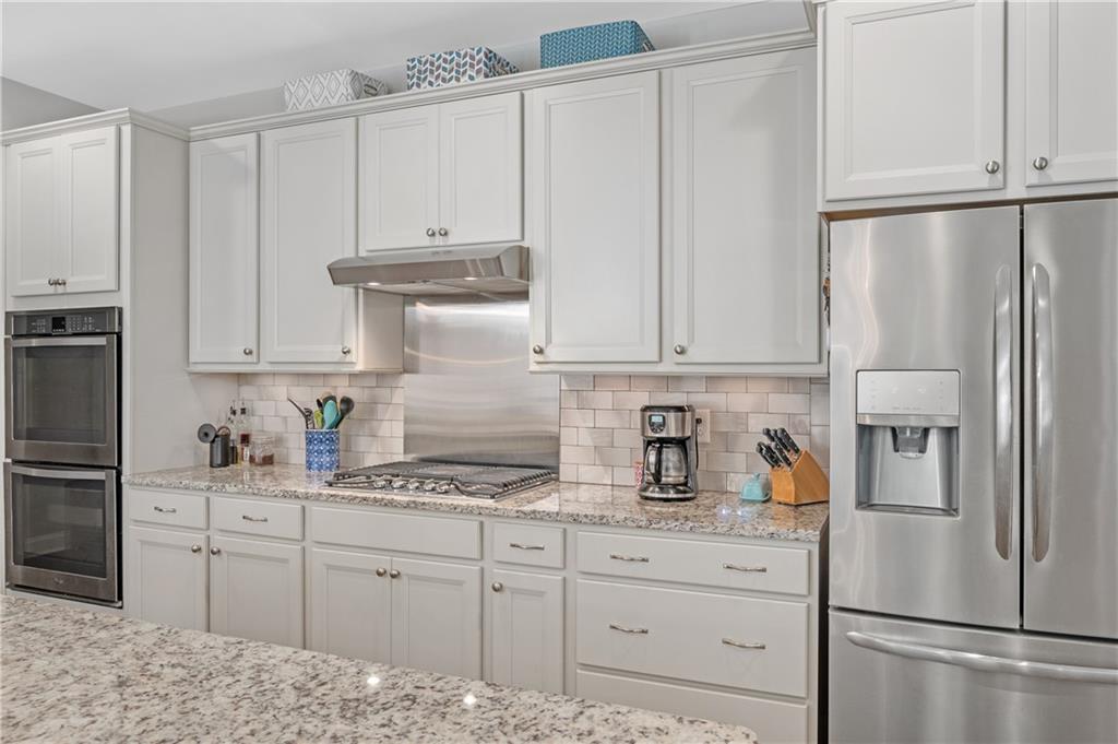 39 Floating Leaf Way Dallas, GA 30132 - Photo 14 of 40 a kitchen with stainless steel appliances granite countertop a refrigerator sink and white cabinets